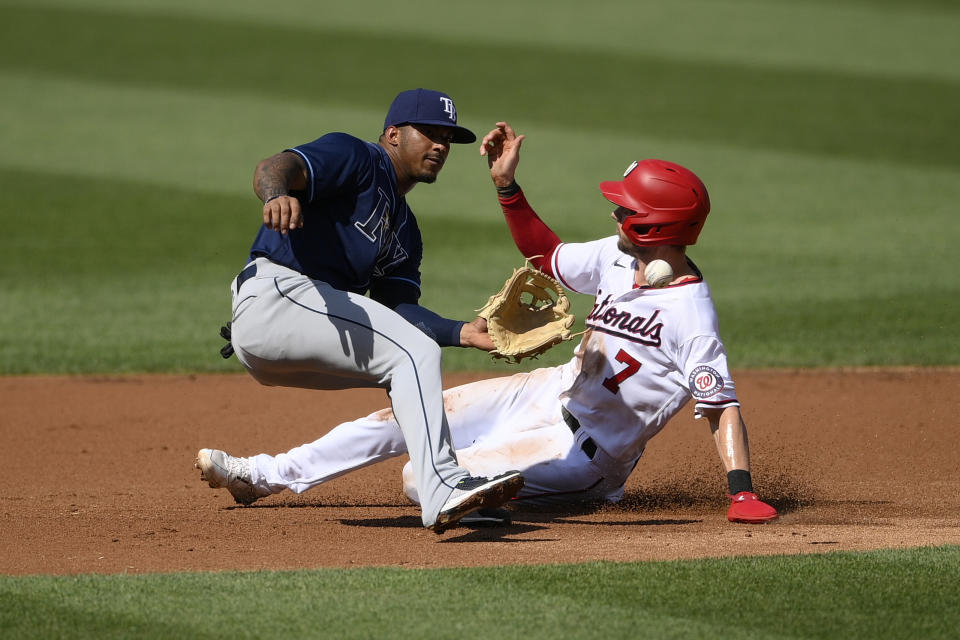 Washington Nationals' Trea Turner (7) slides on his way to stealing second against Tampa Bay Rays shortstop Wander Franco, left, during the first inning of a baseball game, Wednesday, June 30, 2021, in Washington. (AP Photo/Nick Wass)