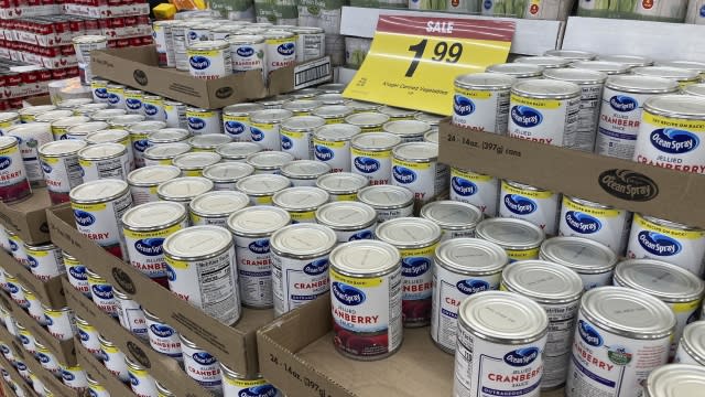 A sale sign tops flats filled with cans of jellied cranberry sauce