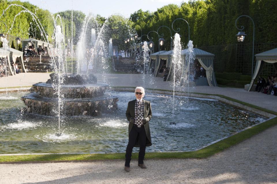 German fashion designer Karl lagerfeld poses at the end of Chanel's show in the Chateau de Versailles, southwest of Paris, Monday, May, 14, 2012. Master of Fashion, Karl Lagerfeld spares no expenses for his midseason Chanel Cruise show offering held at the former home of Marie Antoinette. (AP Photo/Jacques Brinon)