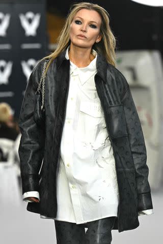 <p>MIGUEL MEDINA/AFP via Getty</p> Kate Moss impersonator Denise walks the Marine Serre show dressed as the iconic supermodel