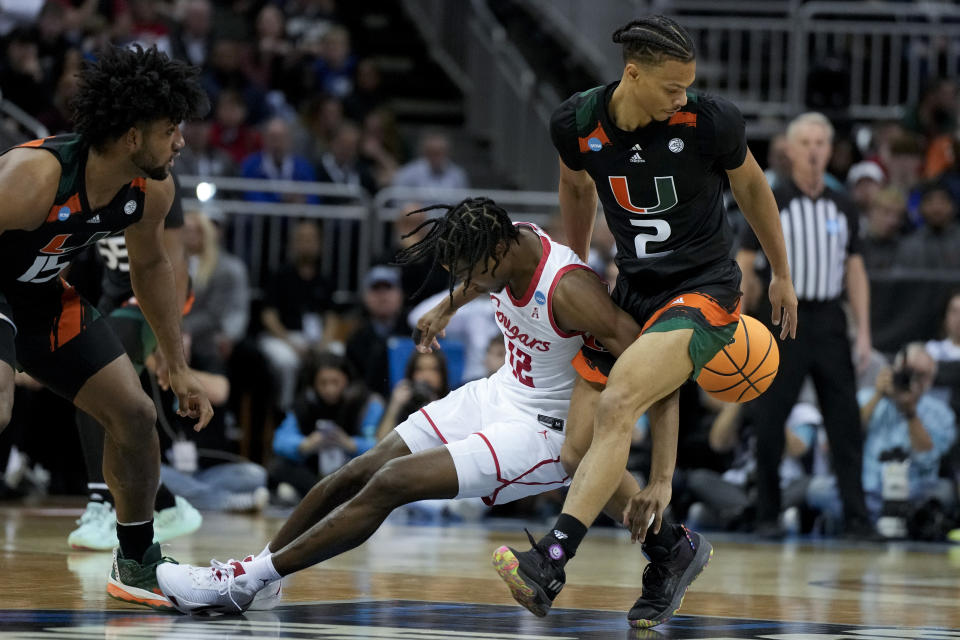 Houston guard Tramon Mark vies for the ball with Miami guard Isaiah Wong in the first half of a Sweet 16 college basketball game in the Midwest Regional of the NCAA Tournament Friday, March 24, 2023, in Kansas City, Mo. (AP Photo/Jeff Roberson)