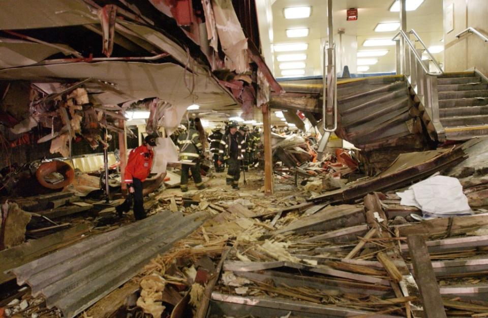 Emergency workers walk through the destroyed interior of the Staten Island Ferry boat Andrew J. Barberi. AP