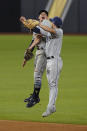 Tampa Bay Rays shortstop Willy Adames and second baseman Brandon Lowe celebrate their win in Game 2 of the baseball World Series against the Los Angeles Dodgers Wednesday, Oct. 21, 2020, in Arlington, Texas. Ray beat the Dodgers 6-4.(AP Photo/Eric Gay)
