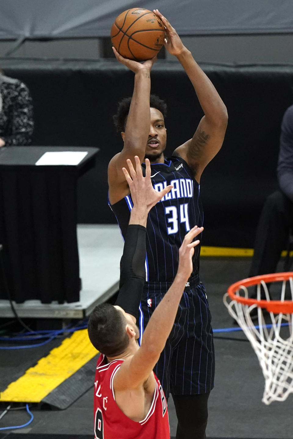 Orlando Magic center Wendell Carter Jr., top, shoots against Chicago Bulls center Nikola Vucevic during the first half of an NBA basketball game in Chicago, Wednesday, April 14, 2021. (AP Photo/Nam Y. Huh)