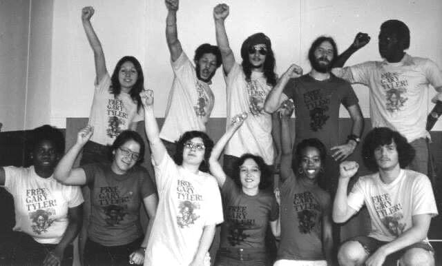 A group shot of people with fists in the air