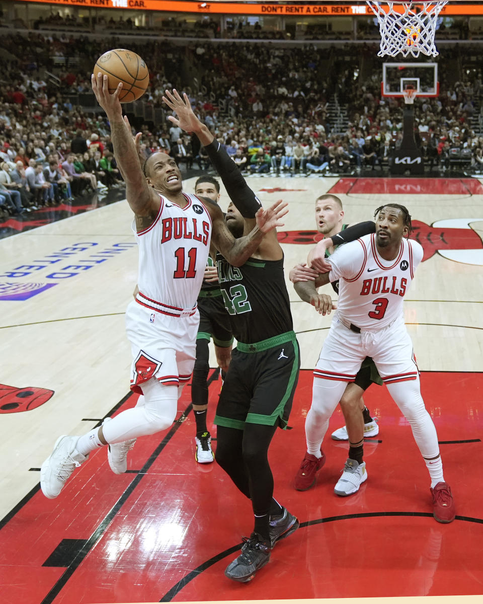 Chicago Bulls' DeMar DeRozan (11) drives to the basket as Boston Celtics' Al Horford (42) defends during the first half of an NBA basketball game Thursday, Feb. 22, 2024, in Chicago. (AP Photo/Charles Rex Arbogast)