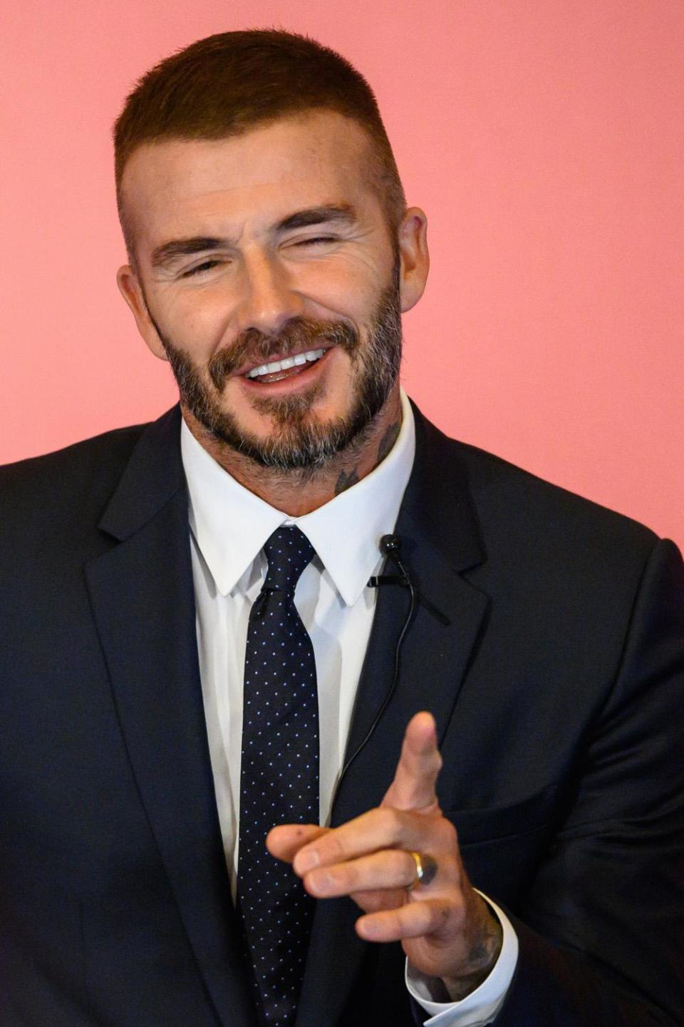 New look: David Beckham appeared happy with his new barnet (Anthony Wallace/AFP/Getty)