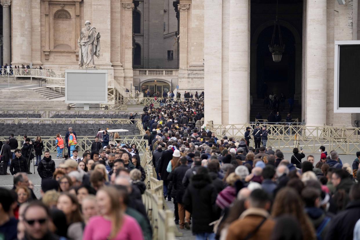 People wait in a line to enter Saint Peter's Basilica at the Vatican where late Pope Benedict 16 is being laid in state at The Vatican, Monday, Jan. 2, 2023. Benedict XVI, the German theologian who will be remembered as the first pope in 600 years to resign, has died, the Vatican announced Saturday. He was 95. (AP Photo/Andrew Medichini)