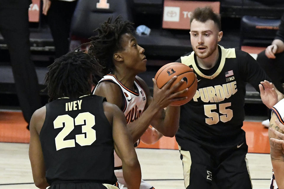 Illinois guard Ayo Dosunmu (11) shoots between Purdue's guards Jaden Ivey (23) and Sasha Stefanovic (55) in the first half of an NCAA college basketball game Saturday, Jan. 2, 2021, in Champaign, Ill. (AP Photo/Holly Hart)