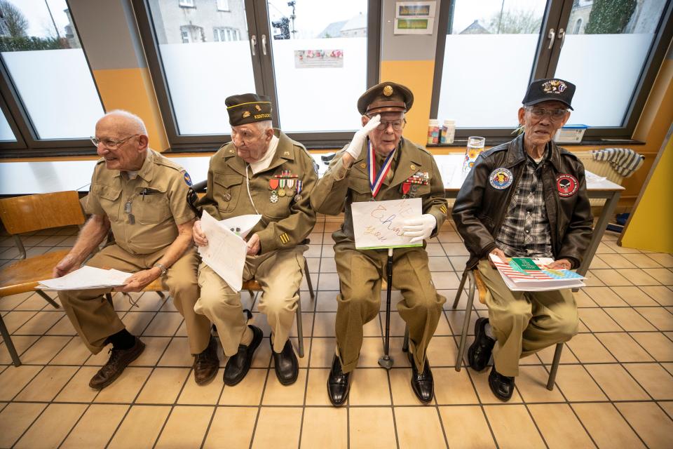 John Pildner Sr. salutes the schoolchildren of the Noville, Belgium, public school during a visit Dec. 13, 2019, as part of the 75th Anniversary of the Battle of the Bulge. From left to right are, Frank Riesinger, George Merz,  Pidner and Robert Izumi, a Vietnam veteran.