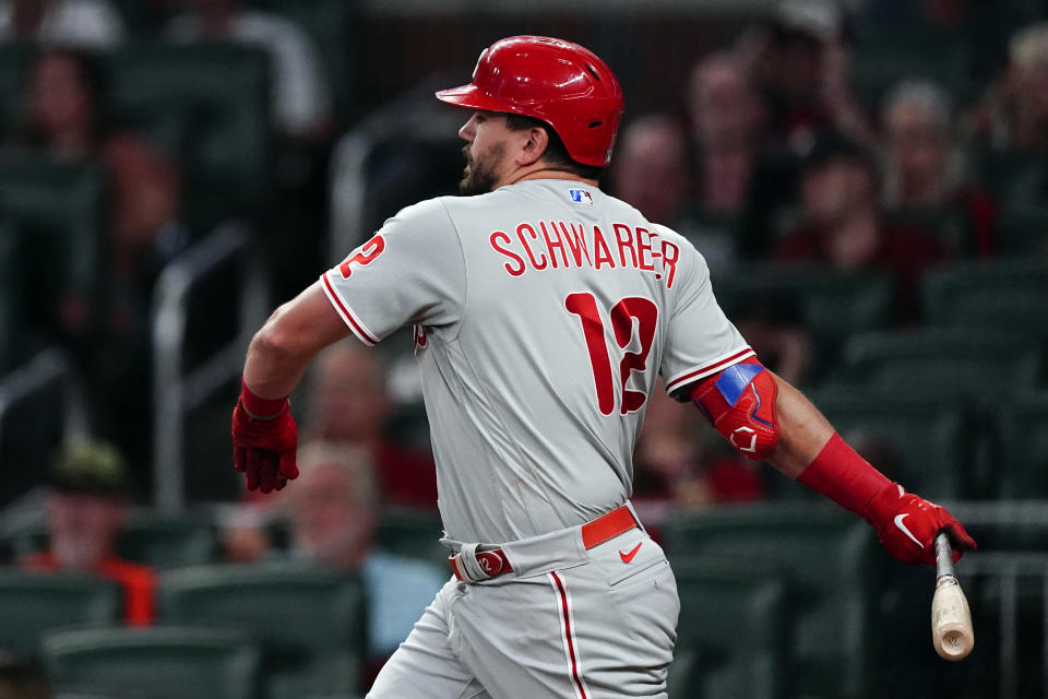 Philadelphia Phillies' Kyle Schwarber follows through on a solo home run in the fourth inning of the team's baseball game against the Atlanta Braves on Friday, Sept. 16, 2022, in Atlanta. (AP Photo/John Bazemore)