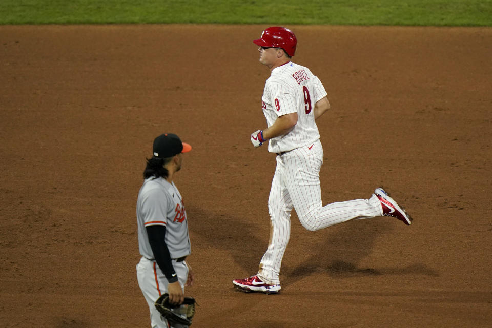 Philadelphia Phillies' Jay Bruce, right, rounds the bases past Baltimore Orioles third baseman Rio Ruiz after hitting a home run off pitcher Alex Cobb during the fifth inning of a baseball game, Tuesday, Aug. 11, 2020, in Philadelphia. (AP Photo/Matt Slocum)