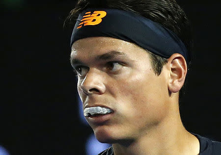 Canada's Raonic bites his mouthguard during his quarter-final match against France's Monfils at the Australian Open tennis tournament at Melbourne Park