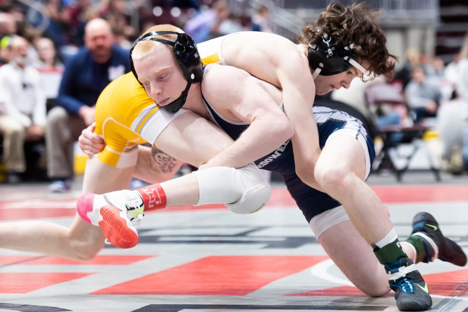 McDowell's Logan Sallot, front, shoots on Central Bucks West's Chris Dennis during their 114-pound quarterfinal bout at the PIAA Class 3A wrestling championships at the Giant Center on Friday in Derry Township. Sallot won by decision, 3-2.