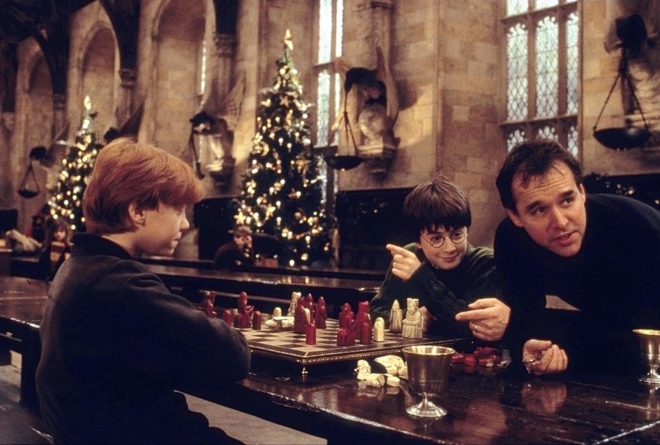 From left to right, Rupert Grint, Daniel Radcliffe and director Chris Columbus in a scene from "Harry Potter and the Sorcerer's Stone."