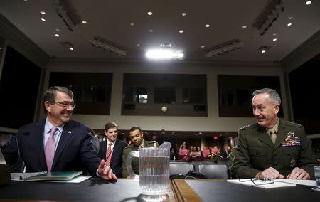United States Secretary of Defense Ash Carter (L) and Joint Chiefs of Staff Chairman USMC General Joseph Dunford, Jr. (R) chat before testifying at a Senate Armed Forces Committee hearing on "United States Strategy in the Middle East" in Washington October 27, 2015. REUTERS/Gary Cameron