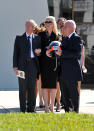 ST PETERSBURG, FL - OCTOBER 22: Dan Wheldon's widow Susie Wheldon (C), his father Clive (R) and her father Sven Behm (L) stand together following his memorial service on October 22, 2011 in St Petersburg, Florida. Wheldon, who was 33 was killed in a 15-car crash at Sunday’s season-ending IndyCar race in Las Vegas. (Photo by Tim Boyles/Getty Images)