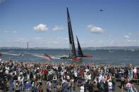 Oracle Team USA crosses the finish line after winning Race 19 and the overall title of the 34th America's Cup yacht sailing race over Emirates Team New Zealand in San Francisco, California September 25, 2013. REUTERS/Stephen Lam