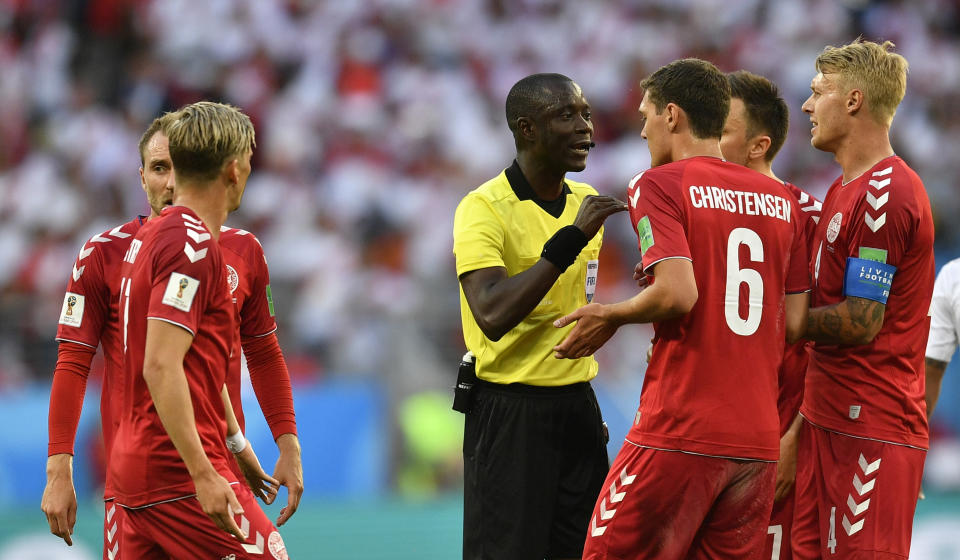 <p>Who’s the boss? Referee Bakari Gassama lays down the law to Andreas Christensen and his Danish teammates. (AP) </p>