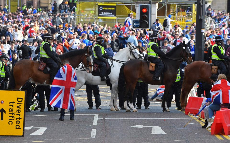 Mounted police stand by as Rangers fans celebrate in George Square in Glasgow - ANDY BUCHANAN/AFP