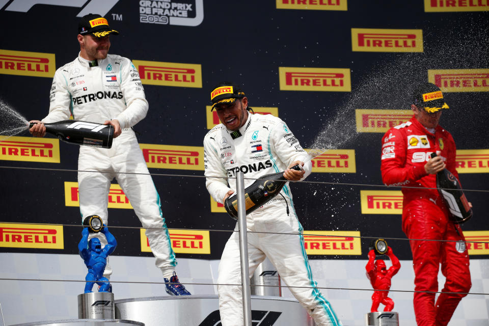 Formula One F1 - French Grand Prix - Circuit Paul Ricard, Le Castellet, France - June 23, 2019       Mercedes' Lewis Hamilton celebrates with sparkling wine on the podium after winning the race alongside second placed Mercedes' Valtteri Bottas and third placed Ferrari's Charles Leclerc    REUTERS/Vincent Kessler
