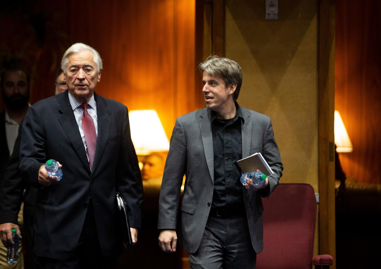 Presenters of the report on the election audit, Randy Pullen (left), the audit spokesman, and Doug Logan, the CEO of Cyber Ninjas, enter the Arizona Senate chambers before the start of the presentation to state lawmakers at the Arizona Capitol in Phoenix on Sept. 24, 2021.