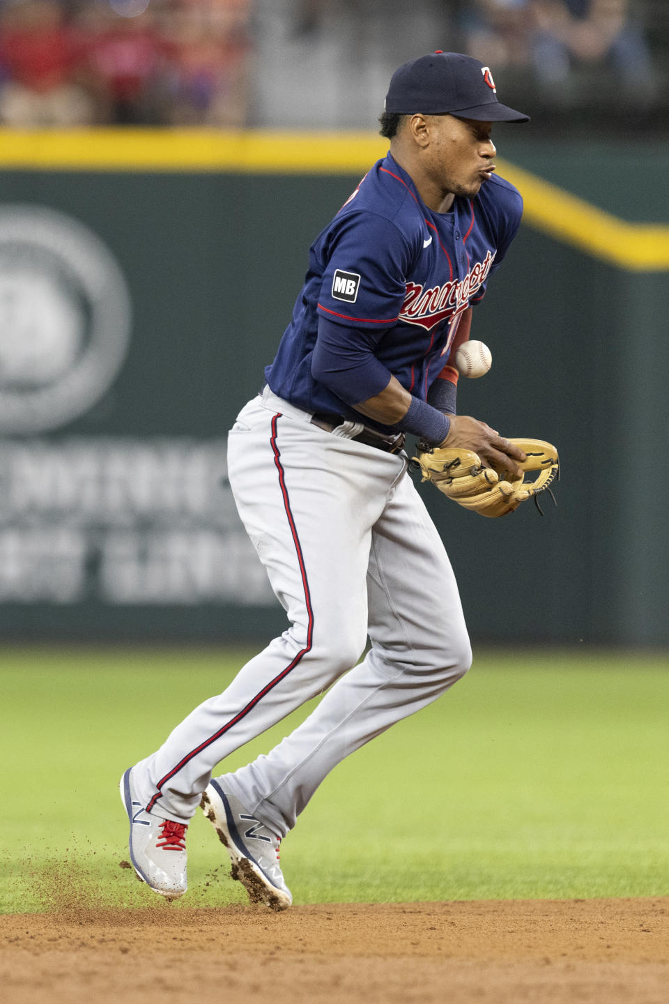 Minnesota Twins shortstop Jorge Polanco makes a fielding error during the second inning of a baseball game against the Texas Rangers in Arlington, Texas, Friday, June 18, 2021. Rangers' Isiah Kiner-Falefa reached first base on the error. (AP Photo/Andy Jacobsohn)