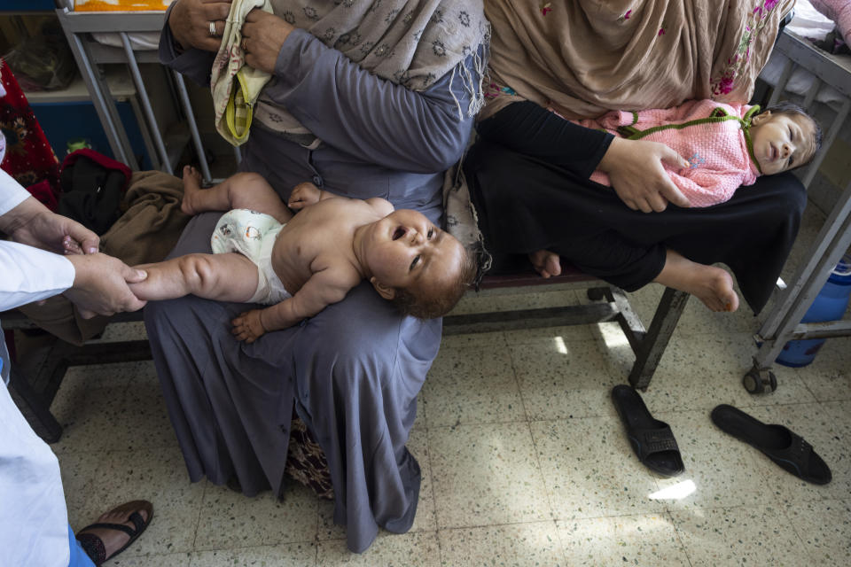 Mothers and their babies in a hospital waiting room.