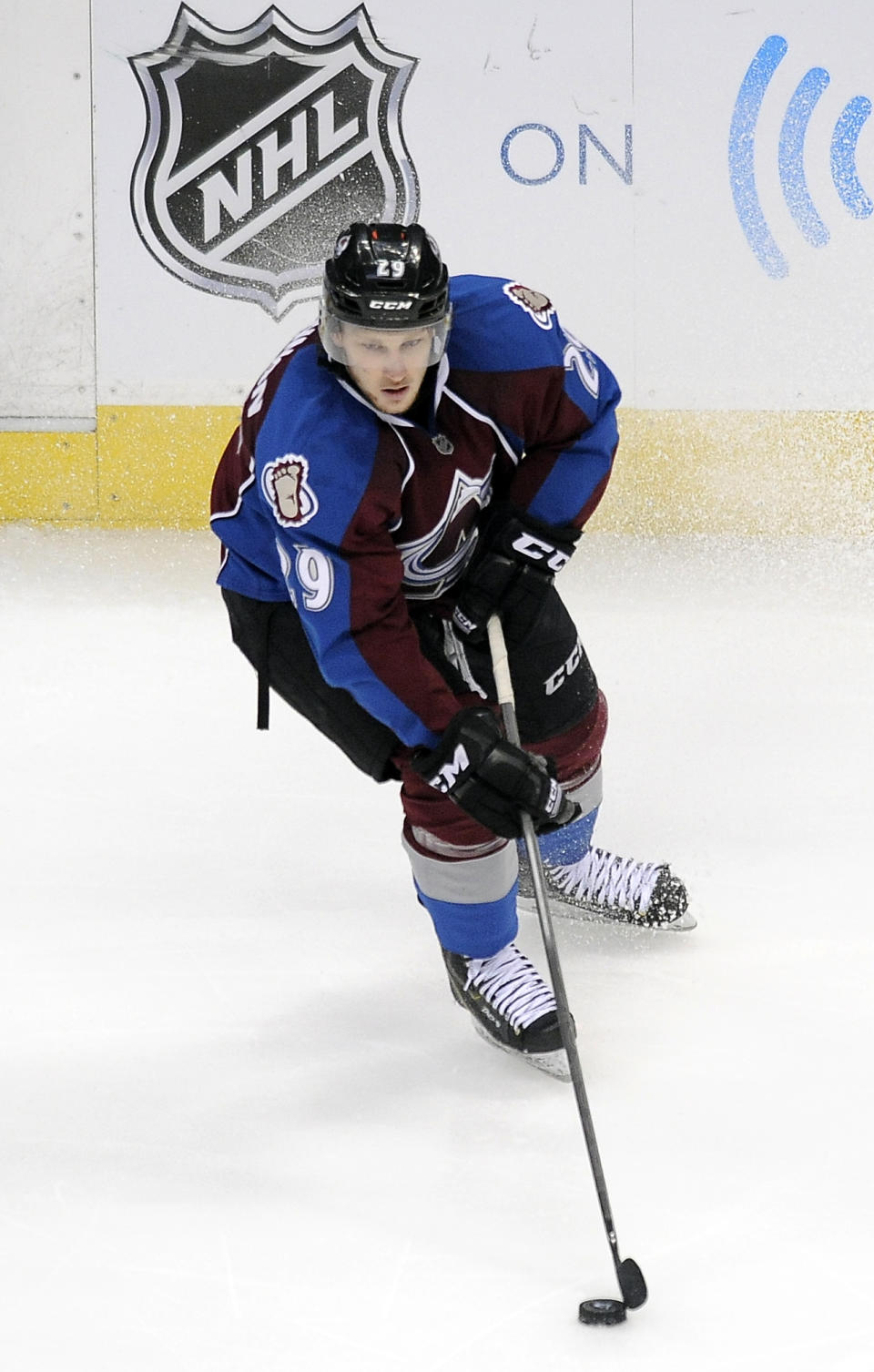Colorado Avalanche center Nathan MacKinnon skates with the puck in overtime in Game 5 of an NHL hockey first-round playoff series against the Minnesota Wild on Saturday, April 26, 2014, in Denver. The Avalanche won 4-3. (AP Photo/Chris Schneider)