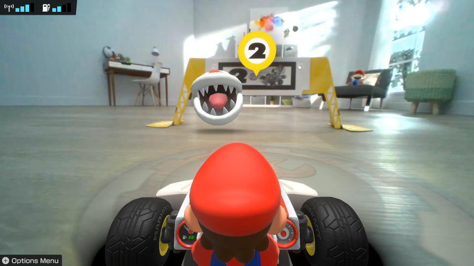 An image of Mario Kart Live: Home Circuit shows a Piranha Plant waiting at the gate.