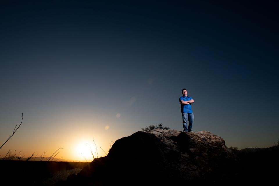 Waylon Pratt went to the desert outside Tuscon, Ariz., for his senior portrait, which required a trip from the family's Michigan home. Photographer Jacquelynn Buck says the students she speaks with are eager to stand out in today's cookie-cutter world.