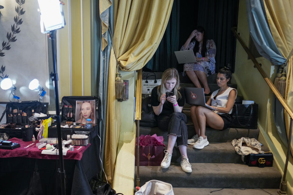 Members of the production crew work backstage ahead of the Christian Siriano collection being modeled during Fashion Week, Friday, Sept. 8, 2023, in New York. (AP Photo/Mary Altaffer)