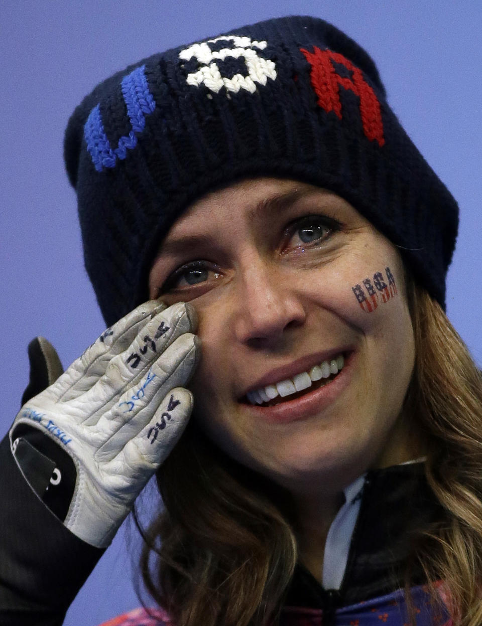 Noelle Pikus-Pace of the United States cries during the flower ceremony after winning the silver medal during the women's skeleton competition at the 2014 Winter Olympics, Friday, Feb. 14, 2014, in Krasnaya Polyana, Russia. (AP Photo/Dita Alangkara)