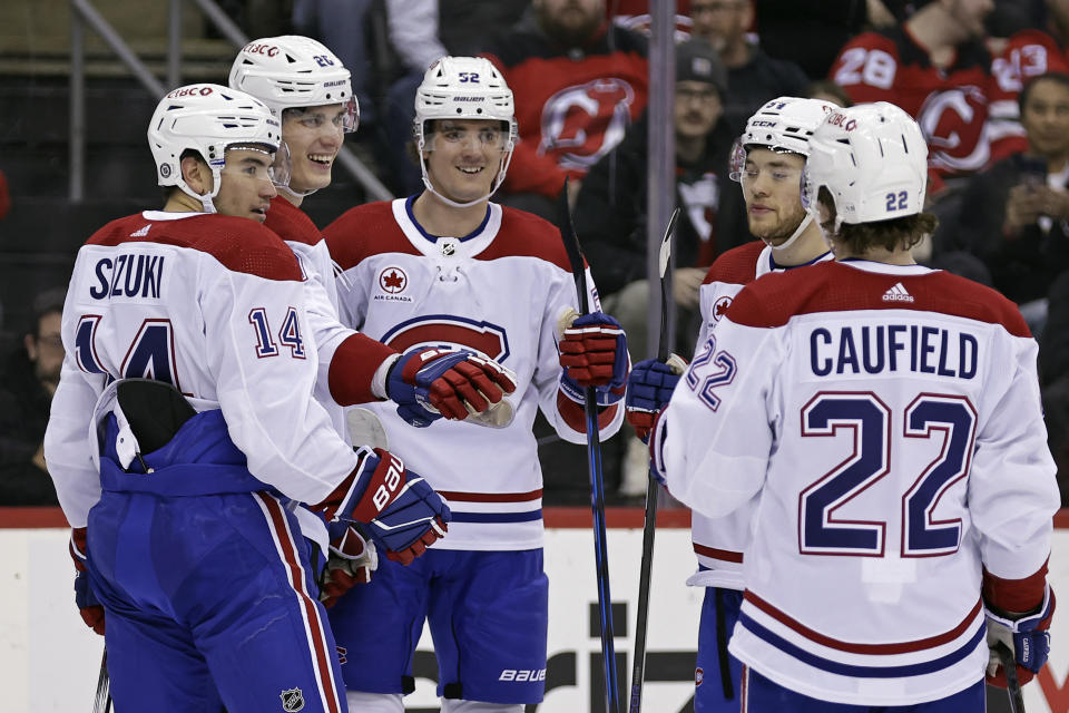 Montreal Canadiens left wing Juraj Slafkovsky, second from left, is congratulated by teammates for his goal against the New Jersey Devils during the first period of an NHL hockey game Wednesday, Jan. 17, 2024, in Newark, N.J. (AP Photo/Adam Hunger)