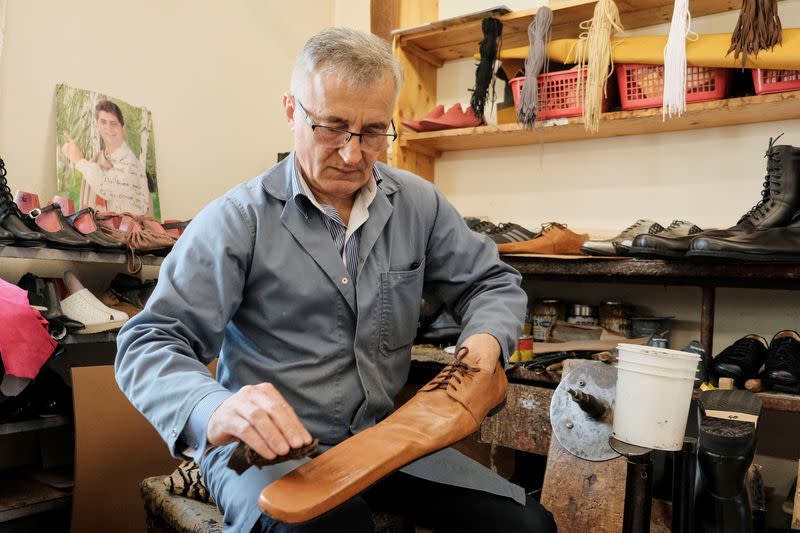 Romanian shoemaker Grigore Lup works on a pair of long-nosed leather shoes, amid the outbreak of the coronavirus disease (COVID-19), in Cluj-Napoca