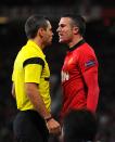 Referee Damir Skomina speaks to Manchester United's Robin van Persie before booking him