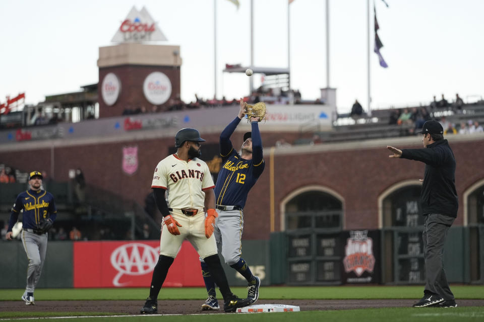 Milwaukee Brewers first baseman Rhys Hoskins (12) catches a popup hit by San Francisco Giants' Matt Chapman during the first inning of a baseball game Wednesday, Sept. 11, 2024, in San Francisco. (AP Photo/Godofredo A. Vásquez)