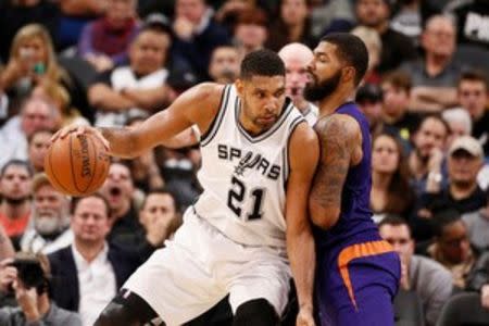 San Antonio Spurs power forward Tim Duncan (21) posts up against Phoenix Suns power forward Markieff Morris (right) during the second half at AT&T Center. Mandatory Credit: Soobum Im-USA TODAY Sports