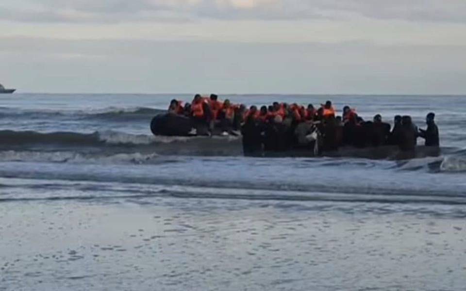 A migrant boat is filmed leaving the French coast near Calais this morning