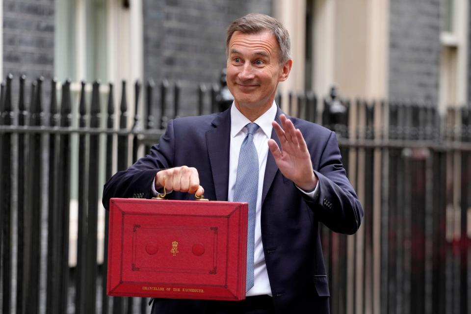 taxpayers Britain's Chancellor of the Exchequer Jeremy Hunt holding his traditional Red ministerial box waves as he leaves 11 Downing Street for the House of Commons to deliver the Budget In London, Wednesday, March 15, 2023. (AP Photo/Kirsty Wigglesworth)