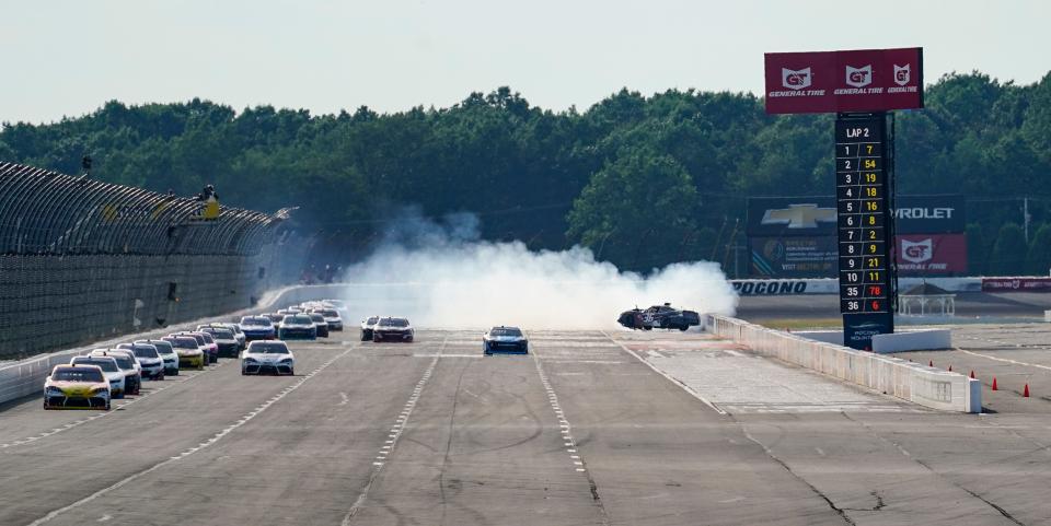 The pack avoids Alex Labbe (36), right, as he spins on the second lap of the NASCAR Xfinity Series auto race at Pocono Raceway, Saturday, July 23, 2022 in Long Pond, Pa. (AP Photo/Matt Slocum)