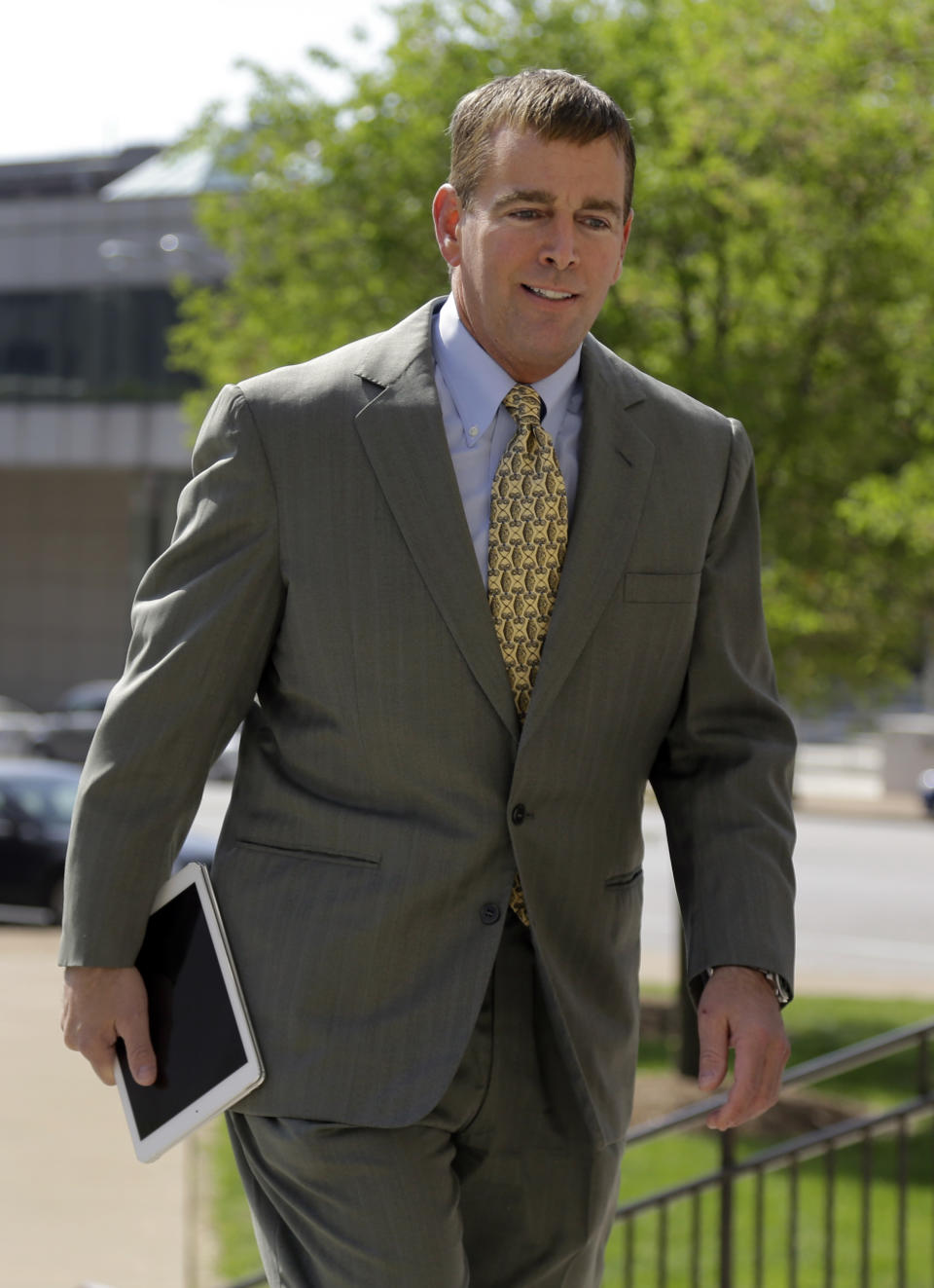 Former Anheuser-Busch CEO August Busch IV enters the Civil Court building before testifying in a gender discrimination lawsuit Tuesday, May 6, 2014, in St. Louis. Francine Katz, former vice president of communications and consumer affairs for the maker of Budweiser, Bud Light and other beers, is suing Anheuser-Busch for gender discrimination. (AP Photo/Jeff Roberson)
