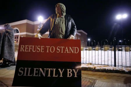 A demonstrator takes part in a protest over the shooting death of Michael Brown in front of the Ferguson Police Department in Ferguson, Missouri, November 17, 2014. REUTERS/Jim Young