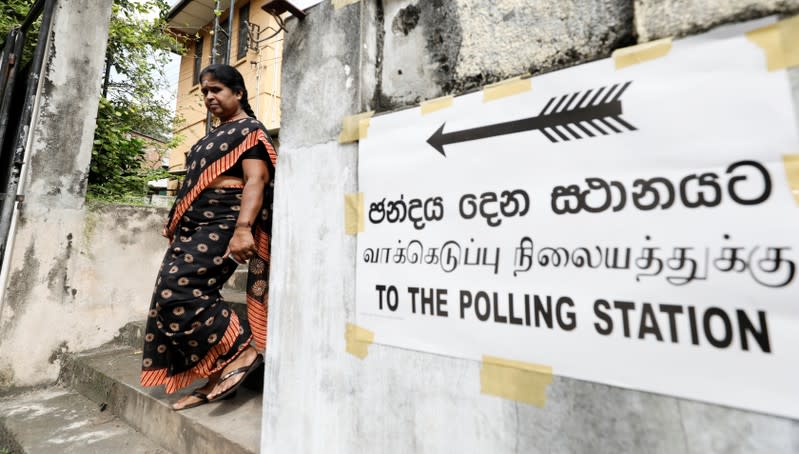 A woman leaves a polling station after casting her vote during the presidential election in Colombo