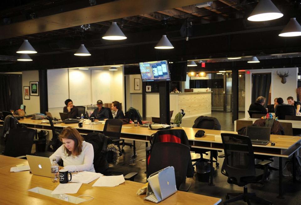 PHOTO: (People work at tables inside of the 'WeWork' co-operative co-working space, March 13, 2013, in Washington, D.C. (Mandel Ngan/AFP via Getty Images, FILE)