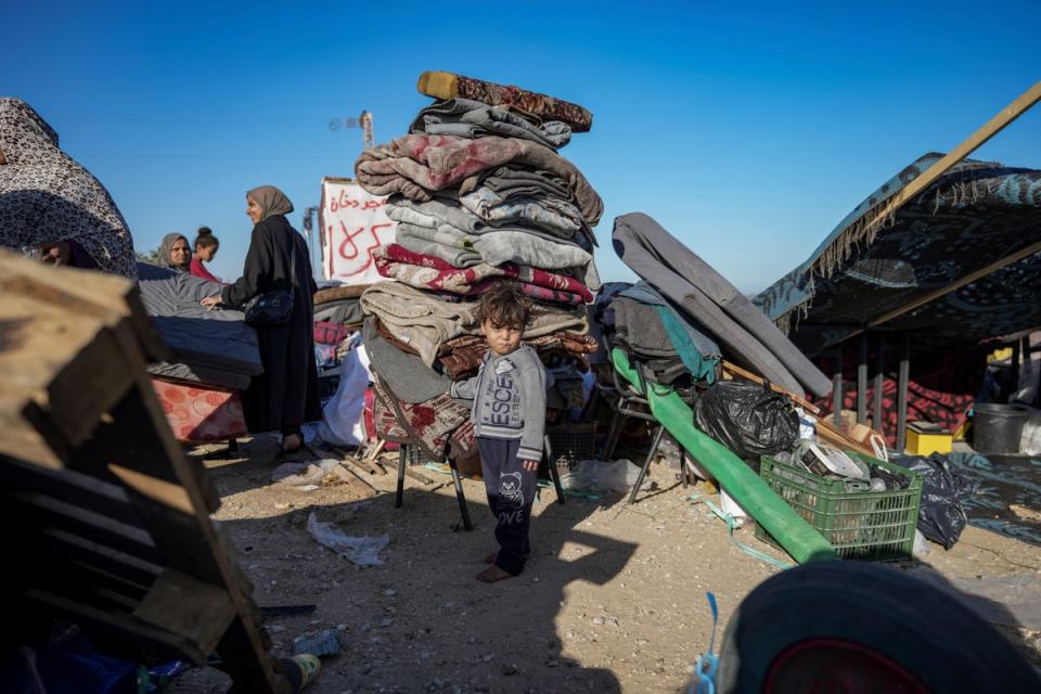 Displaced Palestinians arrive in Deir al-Balah in central Gaza after fleeing from the southern city of Rafah (AP)