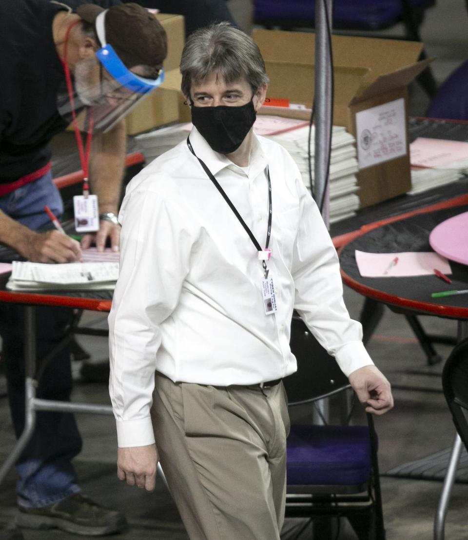 Cyber Ninjas CEO Doug Logan walks around the Coliseum floor as Maricopa County ballots from the 2020 general election are examined and recounted by contractors hired by the Arizona Senate in an audit at the Veterans Memorial Coliseum in Phoenix on May 24, 2021.
