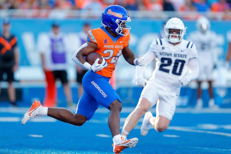 Boise State running back Dylan Riley (24) runs past Utah State linebacker Cole Joyce (20) on a kick 95-yard kick return for a touchdown in the first half of an NCAA college football game, Saturday, Oct. 5, 2024, in Boise, Idaho. . (AP Photo/Steve Conner) | Steve Conner