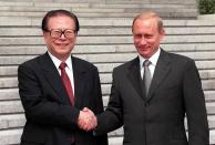 FILE - In this photo released by China's Xinhua News Agency, then Chinese President Jiang Zemin, left, shakes hands with then Russian President Vladimir Putin during a welcome ceremony at the Great Hall of the People in Beijing, July 18, 2000. Chinese state TV said Wednesday, Nov. 30, 2022, that Jiang has died at age 96. (Liu Jianguo/Xinhua via AP, File)