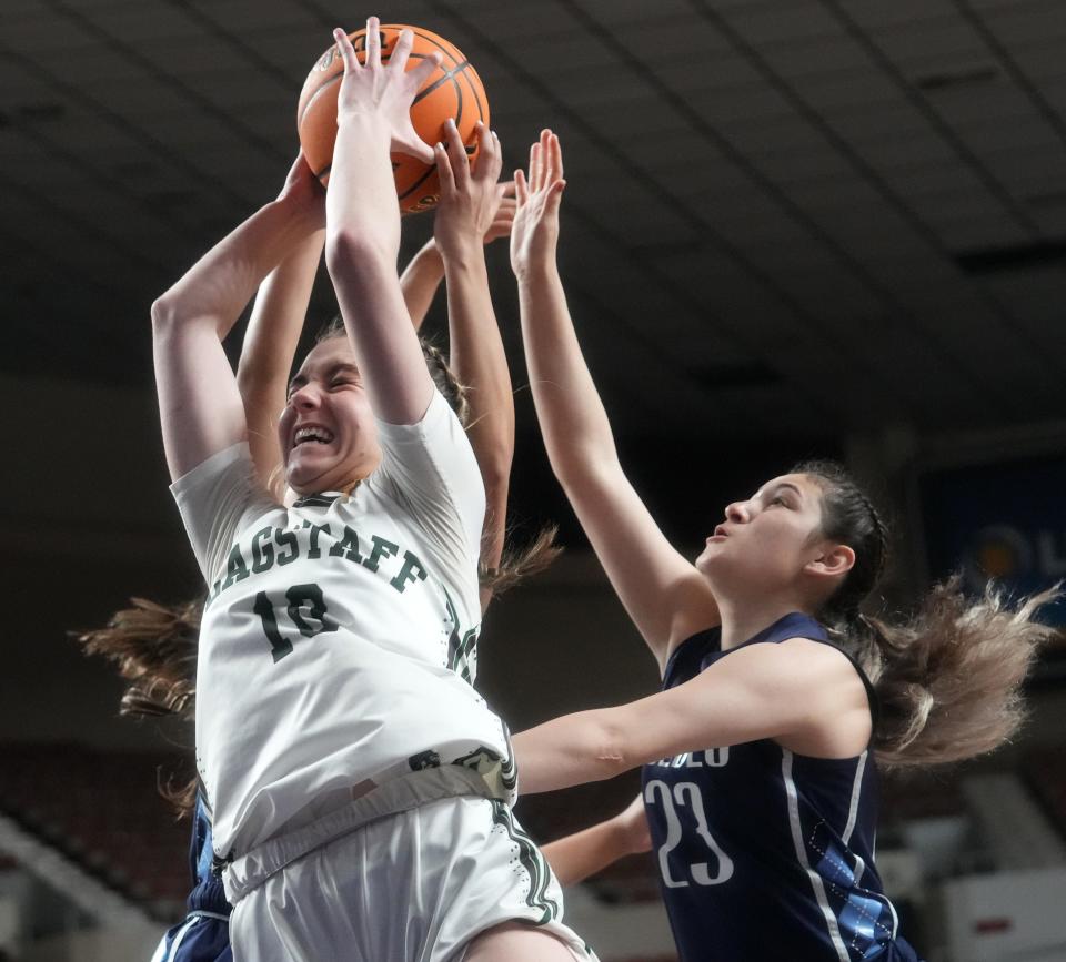 Flagstaff Eagles’ Bella Burcar grabs a rebound against the Pueblo Warriors during their 4A Championship game at Arizona Veterans Memorial Coliseum in Phoenix on March 2, 2023.